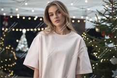 Woman wearing light pink t-shirt with festive lights Product Image 1
