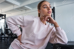 Woman in pink sweatshirt posing in gym fitness Product Image 1
