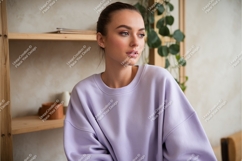 Young woman wearing lavender sweatshirt mockup indoor Product Image 1