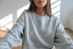 Woman wearing light blue sweatshirt Product Image 1