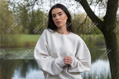 Woman wearing cream sweatshirt outdoors Product Image 1