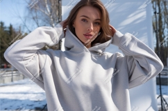 Woman wearing light grey hoodie outdoors casual Product Image 1