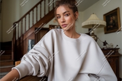 Woman wearing cream sweatshirt indoors Product Image 1