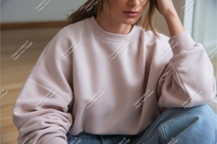 Woman wearing pink sweatshirt and blue jeans image Product Image 1