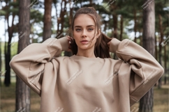 Woman wearing beige sweatshirt in forest nature Product Image 1