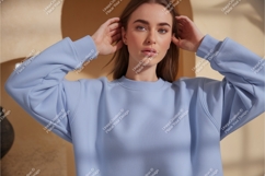 Young Woman Wearing Blue Sweatshirt clothing fashion Product Image 1