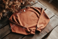 Brown sweatshirt on wooden table mockup Product Image 1