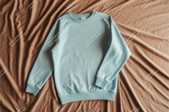 Blue sweatshirt on brown fabric mockup Product Image 1