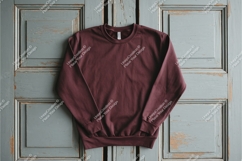 Maroon sweatshirt on wooden door mockup Product Image 1