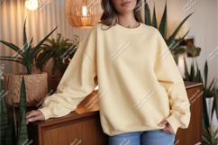 Woman wearing yellow sweatshirt mockup Product Image 1
