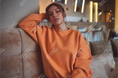 Woman in orange sweatshirt mockup Product Image 1