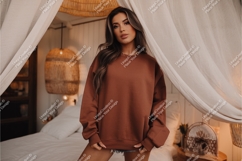 Woman in a sweatshirt in bedroom mockup Product Image 1