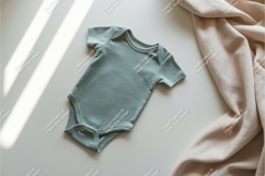 Baby onesie on white surface mockup Product Image 1