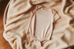 Beige baby onesie with wooden toy mockup Product Image 1