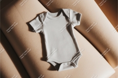 Gray baby onesie on beige cushion mockup Product Image 1