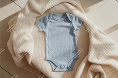 Blue baby onesie on beige sweater mockup Product Image 1