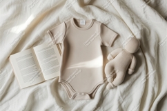 Beige baby bodysuit with toy and book mockup Product Image 1