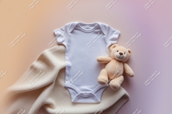 Baby onesie with a teddy bear and blanket mockup Product Image 1