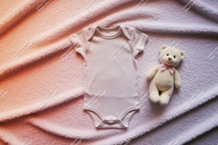 A baby onesie with a teddy bear on blanket mockup Product Image 1