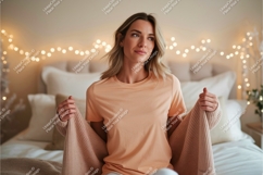 Woman wearing peach t shirt and holding beige cardigan Product Image 1