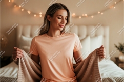 Woman wearing peach t shirt holding blanket Product Image 1