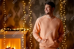 Man wearing peach sweatshirt with fireplace lights Product Image 1