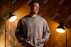Man wearing taupe sweatshirt with hands in pockets Product Image 1
