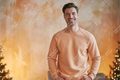 Smiling man wearing peach sweatshirt Product Image 1