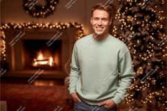 Man wearing mint sweatshirt by fireplace and christmas tree Product Image 1