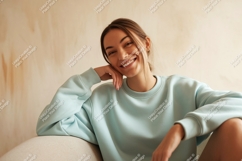 Young Woman Smiling Wearing Pastel Blue Sweatshirt Product Image 1