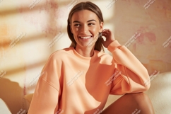 Smiling woman wearing peach sweatshirt casual Product Image 1