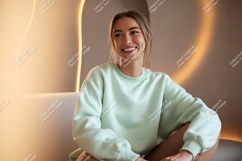 Young Woman Smiling Wearing Mint Green Sweatshirt Product Image 1
