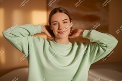 Woman wearing light green sweatshirt mockup Product Image 1