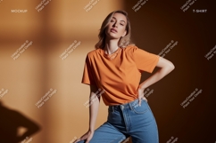 Woman wearing orange t shirt and blue jeans Product Image 1