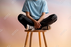 Person sitting on stool blue shirt black pants image Product Image 1
