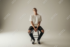 Format: Title: Young man seated wearing ripped jeans Product Image 1