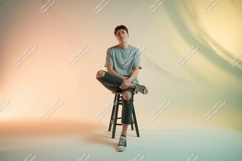 Young man seated on stool male person Product Image 1