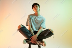 Young man sitting cross legged cross-legged jeans Product Image 1