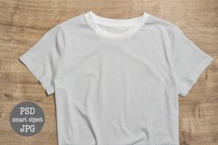 Mock up white t-shirt empty plain on wooden background
