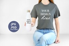 Gray t-shirt & white bottle Mockup PSD, Woman holding Mock Product Image 1