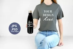 Gray t-shirt & black bottle Mockup PSD, Woman holding Mock Product Image 1