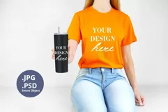 Orange t-shirt & 20oz tumbler mockup, Woman holding PSD JPG Product Image 1