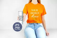 Orange t-shirt & White tumbler mockup, Woman holding PSD JPG Product Image 1