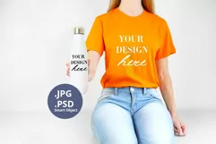 Orange t-shirt & White Bottle mockup, Woman holding PSD JPG Product Image 1