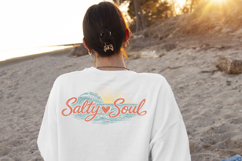 Coastal sublimation design with textured ocean waves and sunset rays behind the phrase “Salty Soul” in beach inspired colors.