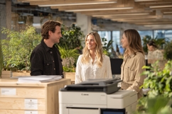Diverse office team collaborating near printer in modern Product Image 1