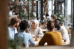 Diverse colleagues collaborating around table in modern Product Image 1