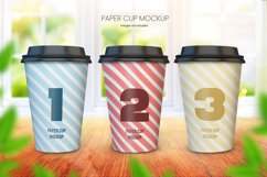 	 Paper coffee cup mockup of three cups on wooden tabletop with bright window background