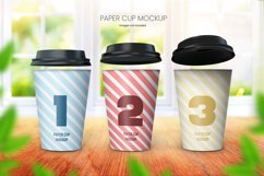 	 Paper coffee cup mockup of three cups on wooden tabletop with bright window background