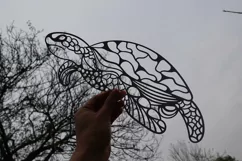 paper cut turtle in woods